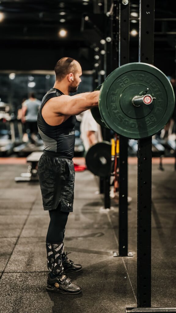 An athlete lifting weights in a modern gym