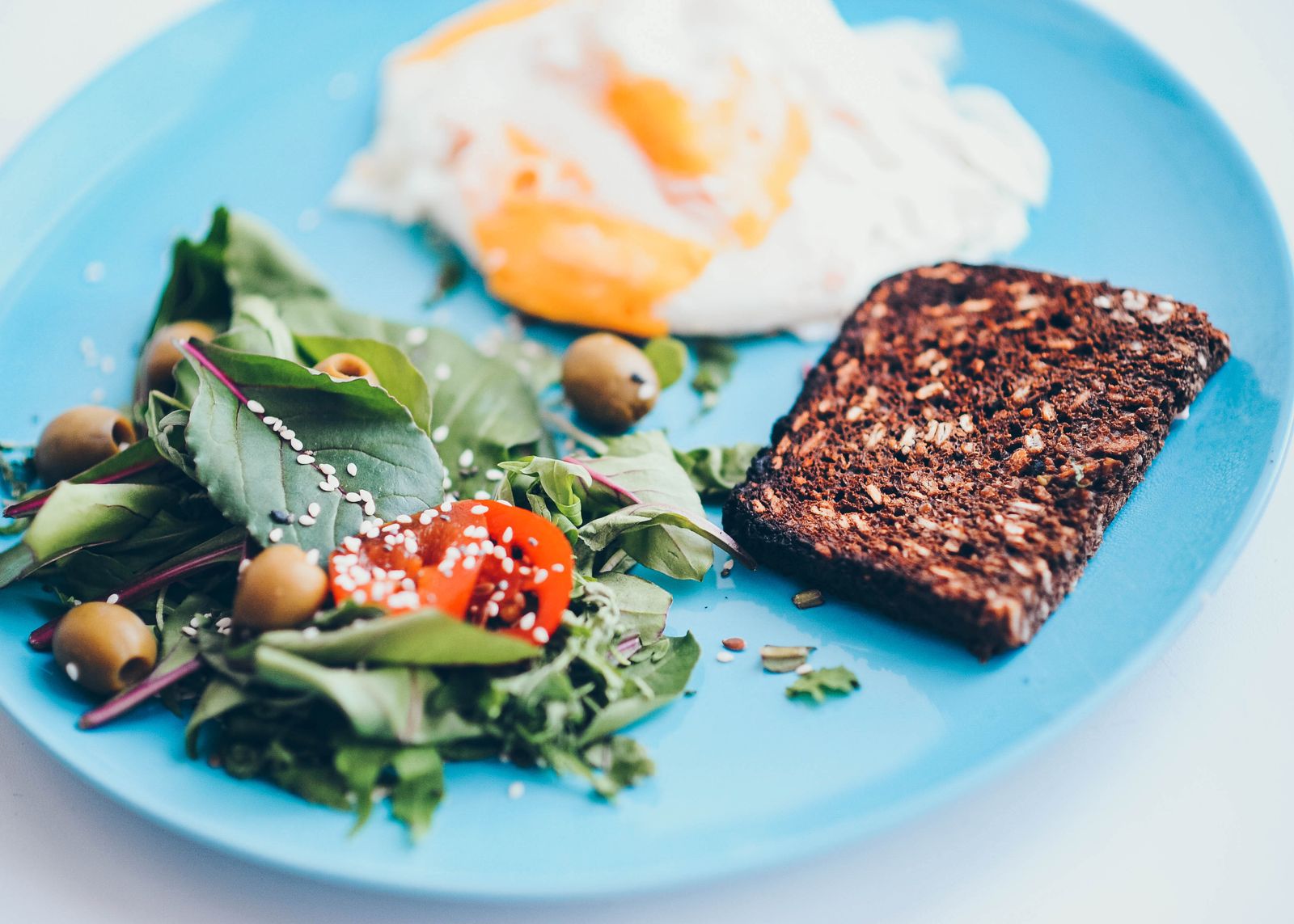 A balanced, colorful plate with eggs, whole grains, and vegetables