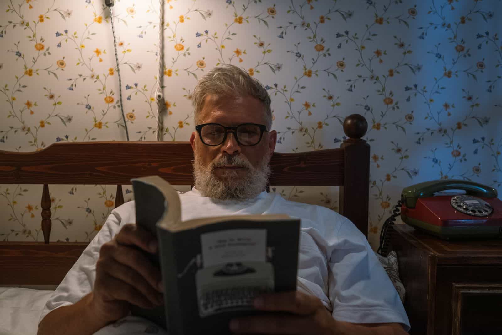 An older man enjoying quiet evening reading before bed