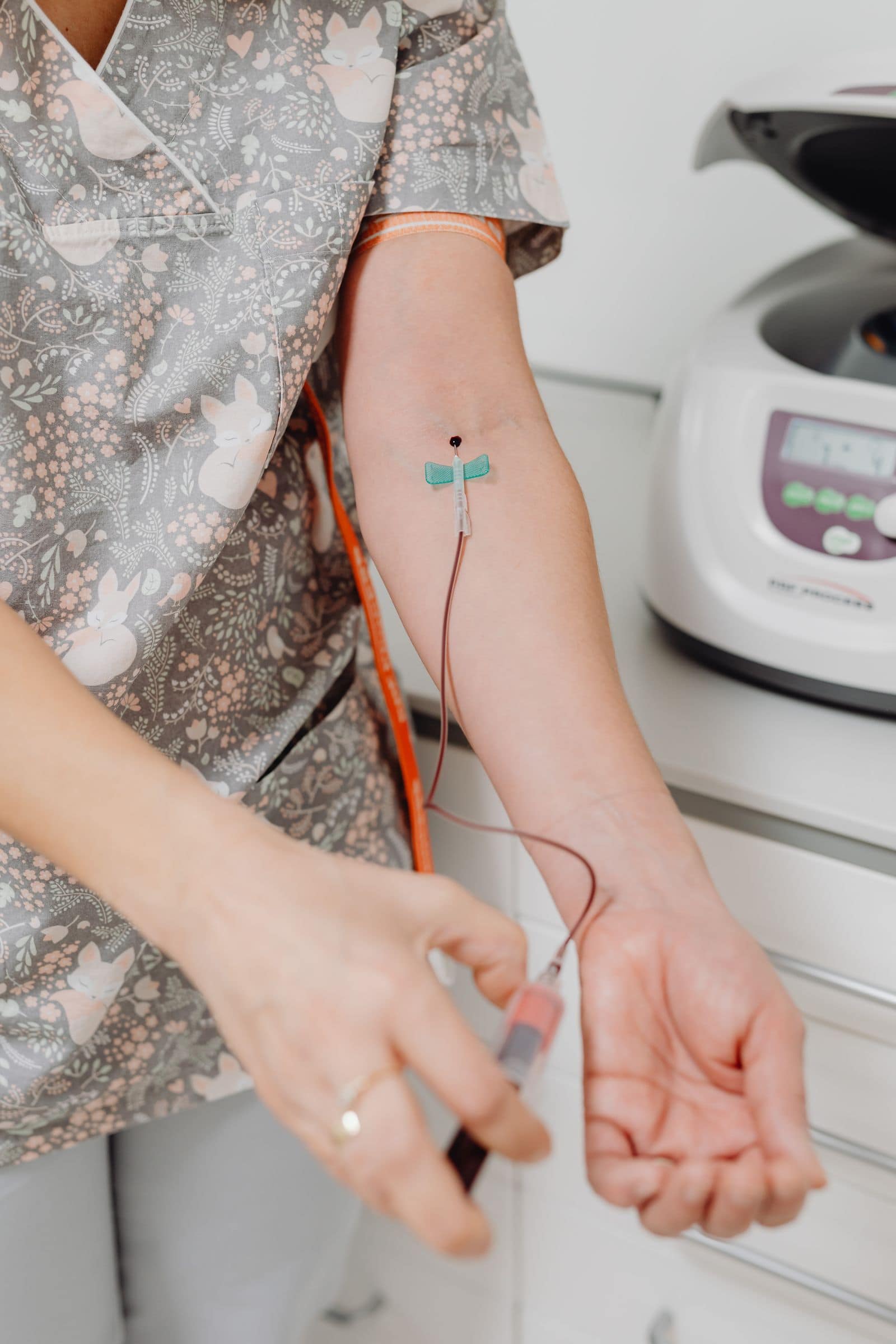 A nurse drawing blood from a patient's arm for lab testing