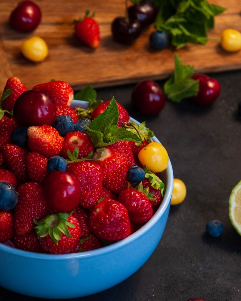 A colorful bowl of mixed berries and fruits