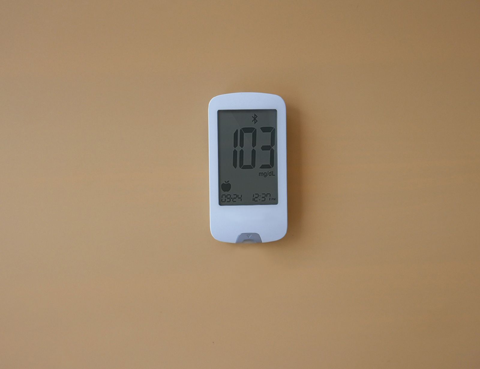 A digital glucose meter displaying a blood sugar level