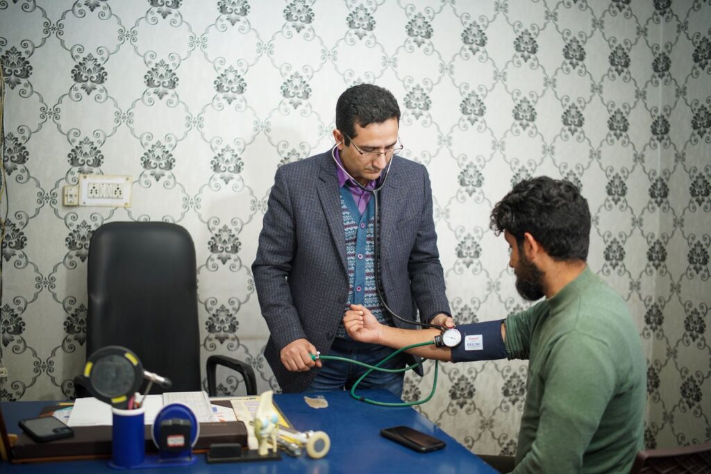 A doctor checking a patient’s blood pressure during a consultation