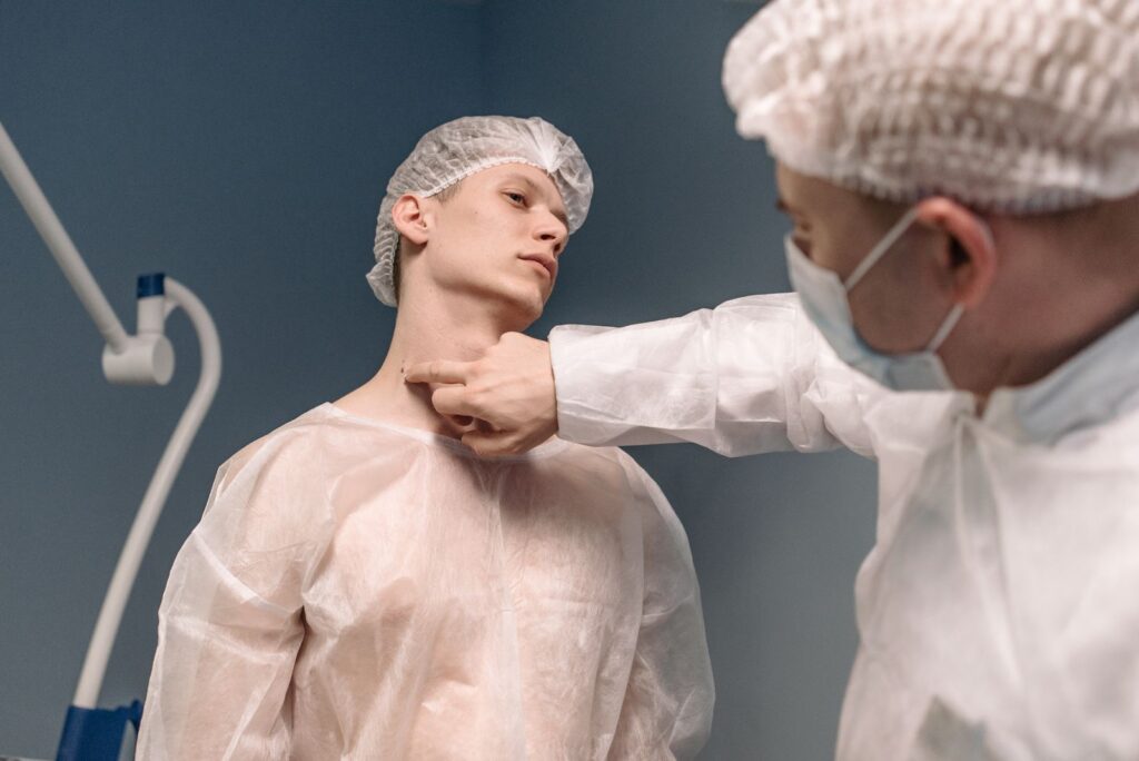 A doctor examining a patient’s neck in a clinical setting