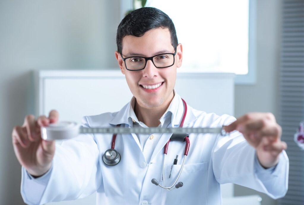 A friendly doctor holding a measuring tape in a clinic setting