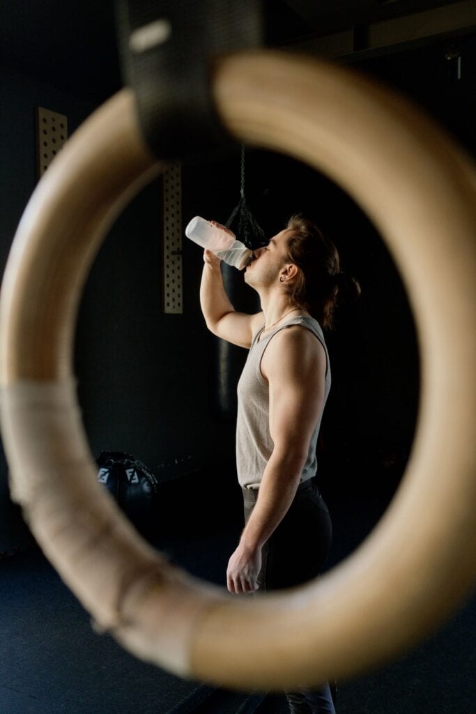 Athlete drinking from a water bottle at the gym