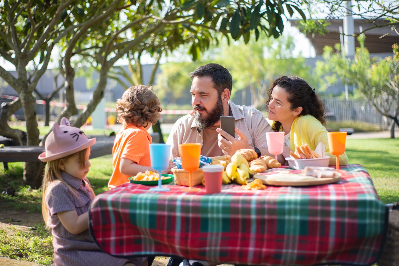A family enjoying an outdoor picnic together in a park