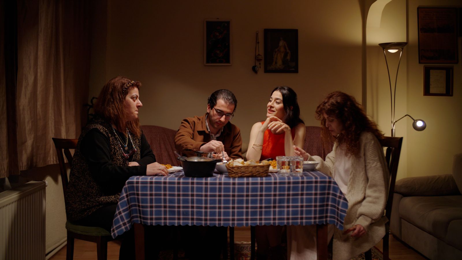 Four people sharing a cozy evening meal together