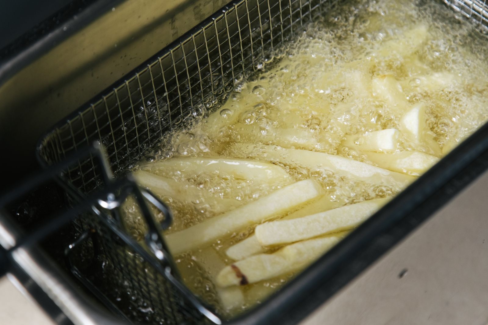 French fries being deep-fried in oil