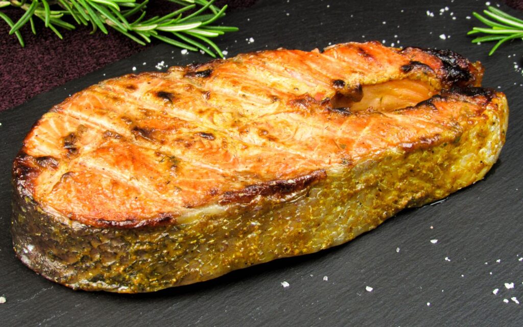 A grilled salmon steak, a rich source of omega-3 fatty acids