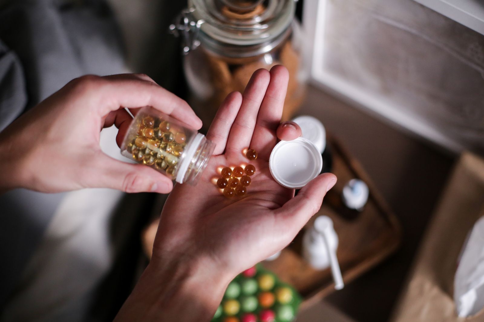 Hands carefully holding supplement capsules
