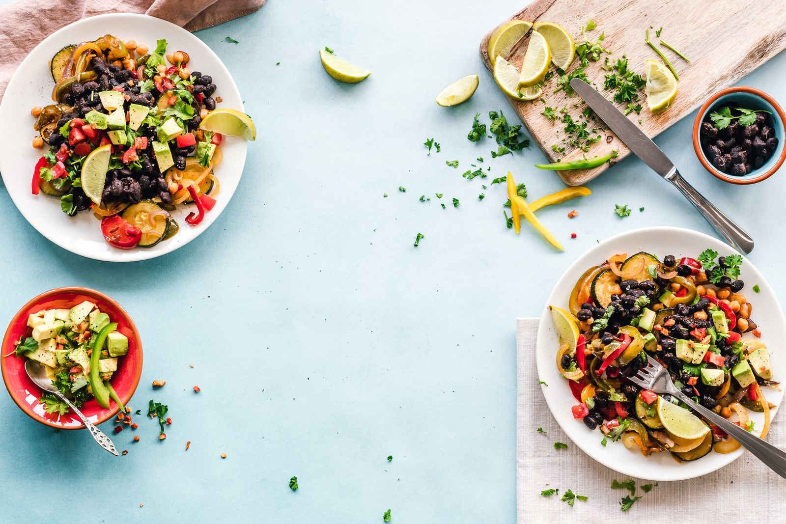A colorful healthy meal with avocado, beans, and vegetables