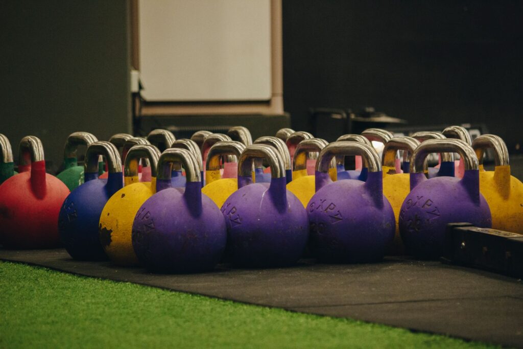 Vibrant kettlebells arranged on the gym floor for functional training