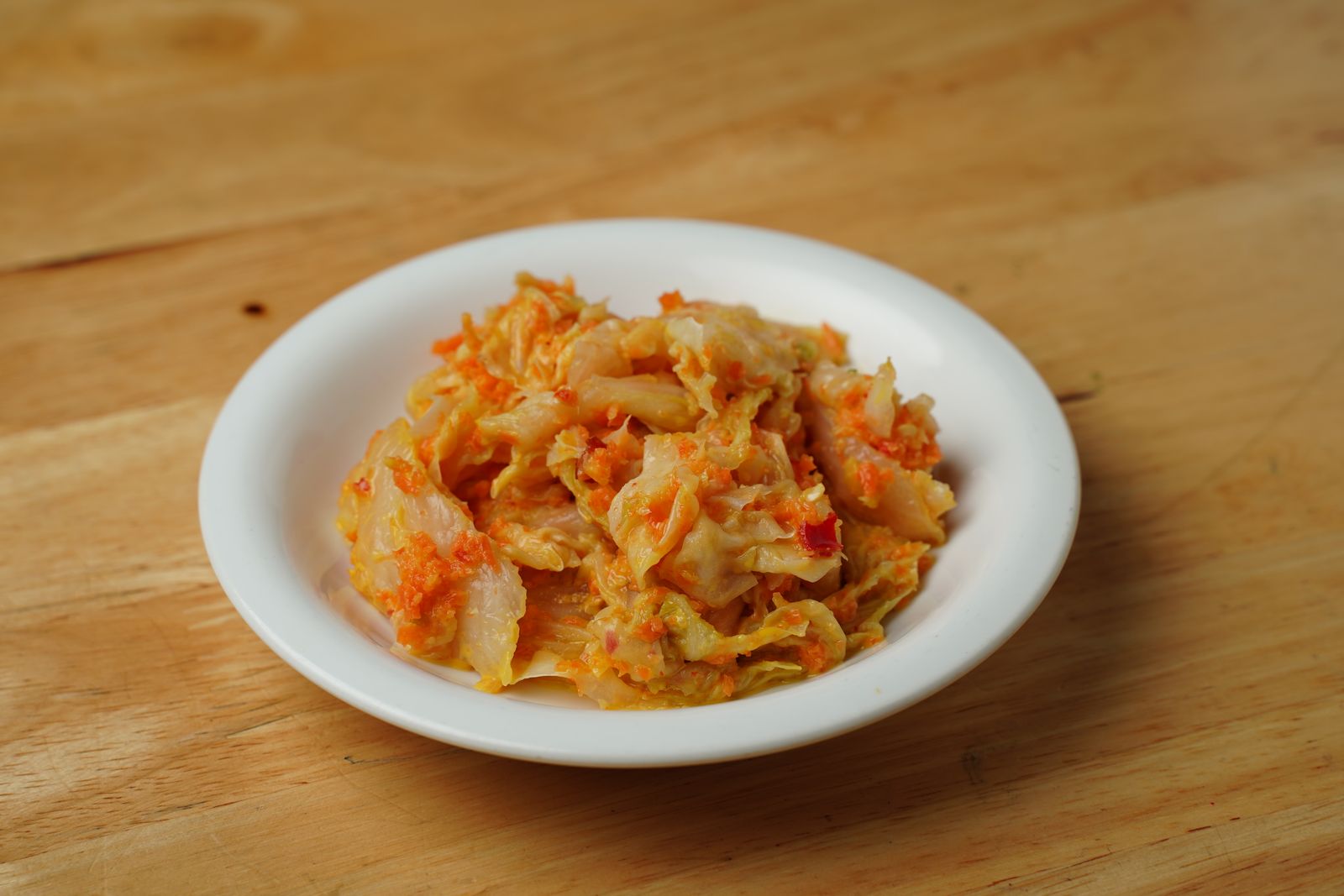 Korean kimchi served in a white ceramic bowl
