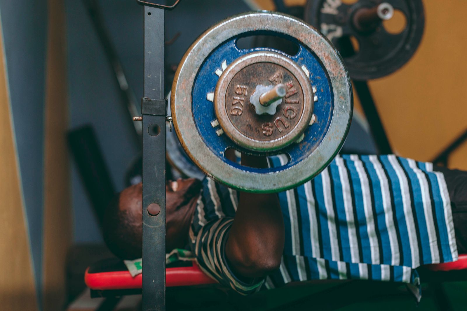 A man performing a bench press with a barbell
