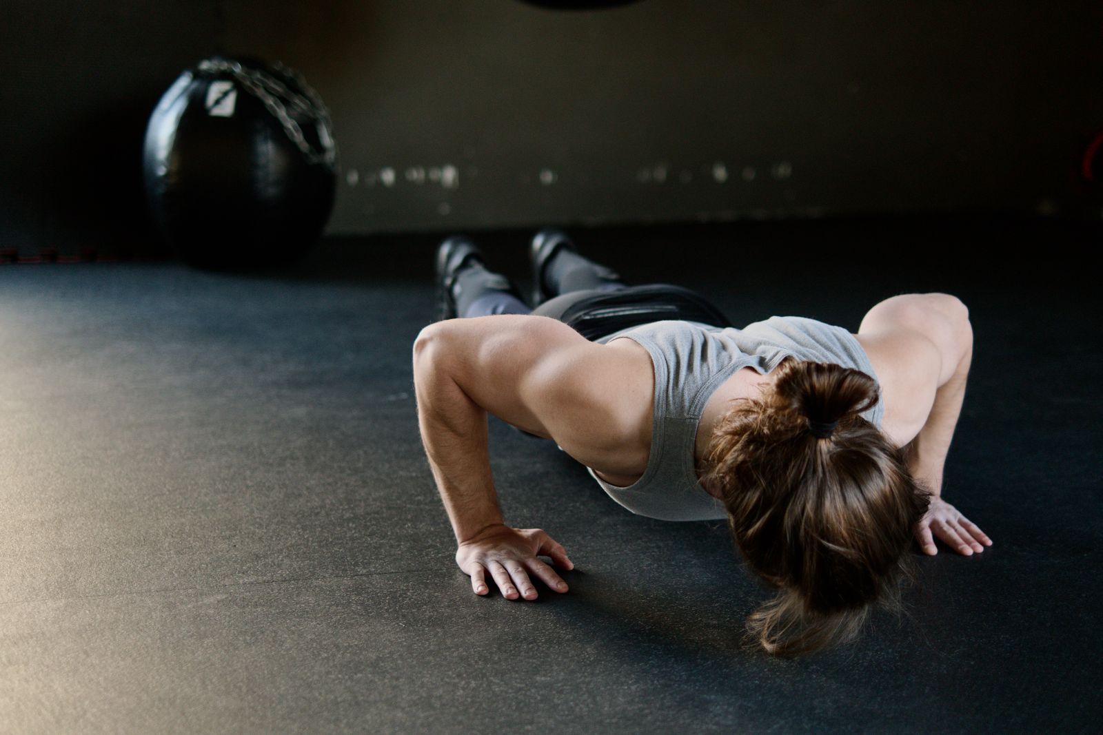 A man engaged in a push-up exercise on the gym floor