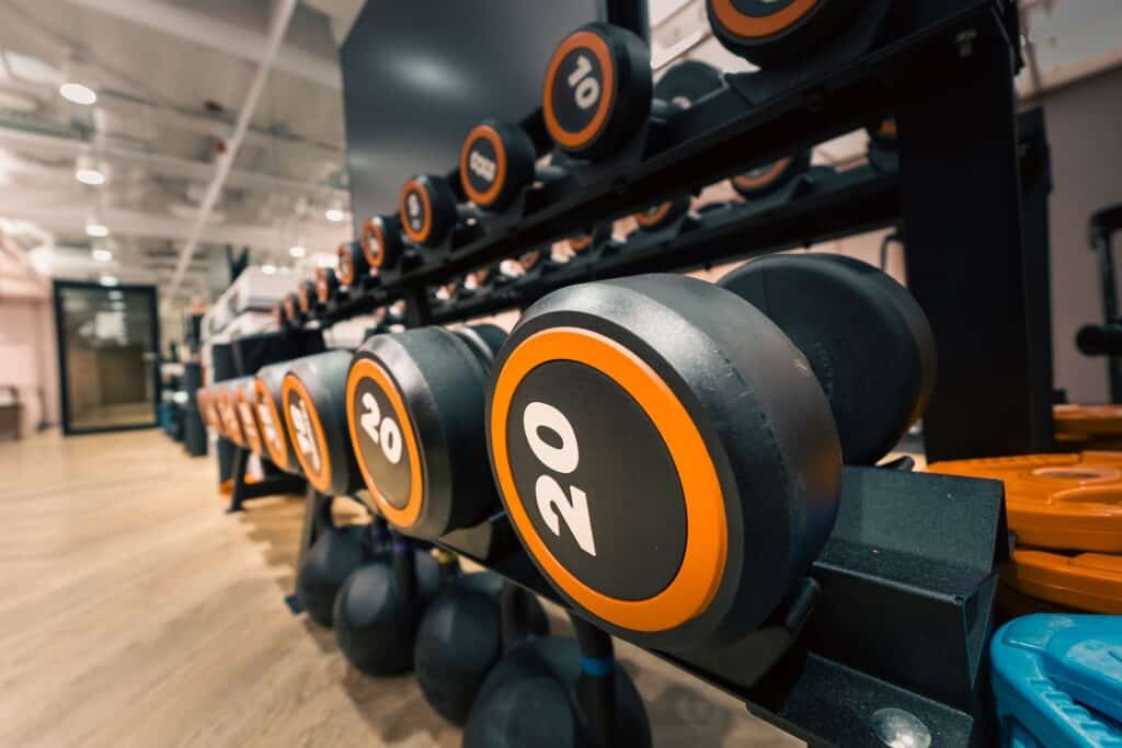 Close-up of dumbbells in a gym, representing progressive overload in strength training