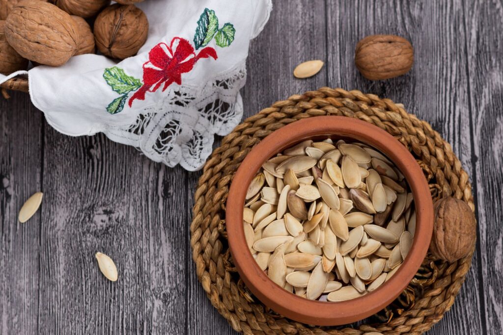 Pumpkin seeds and walnuts in a bowl, food sources of zinc