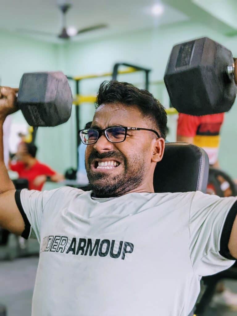 Man lifting weights with visible effort, illustrating high perceived exertion
