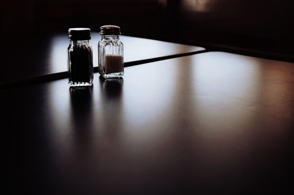 A still life of salt and pepper shakers on a table
