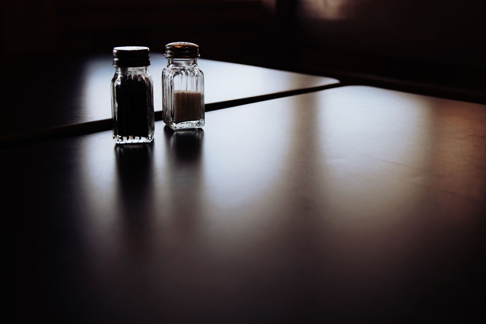 A still life of salt and pepper shakers on a table