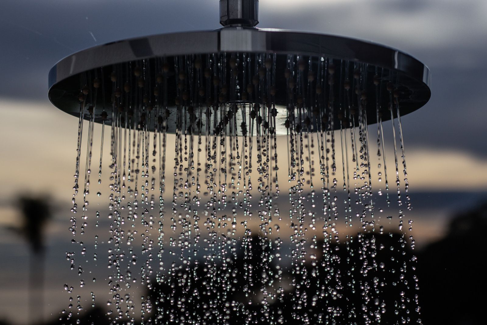 A shower head with water drops flowing