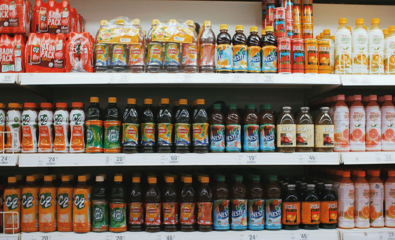 Rows of colorful sugary drinks on a grocery store shelf