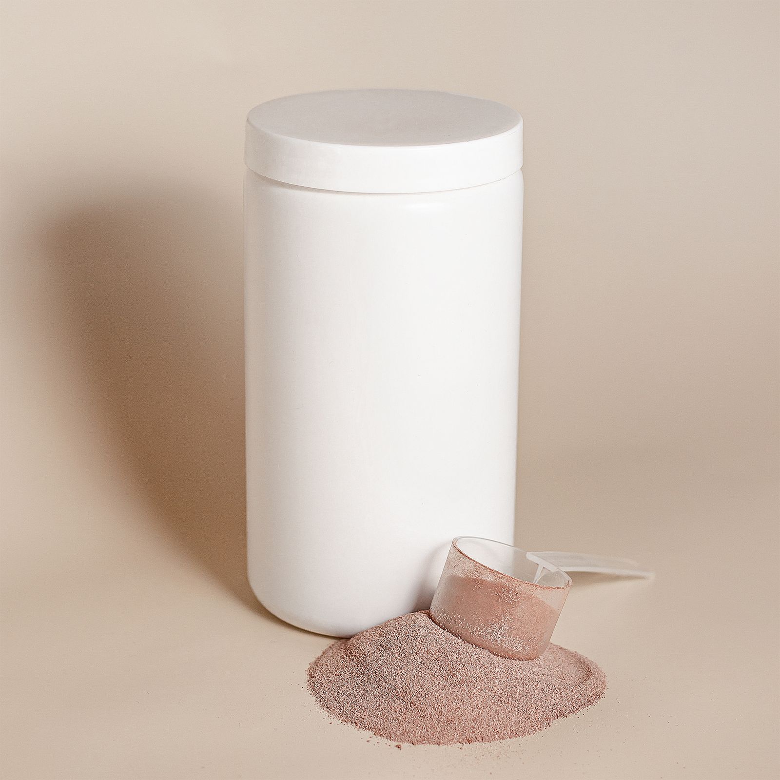 A container of supplement powder with a scoop