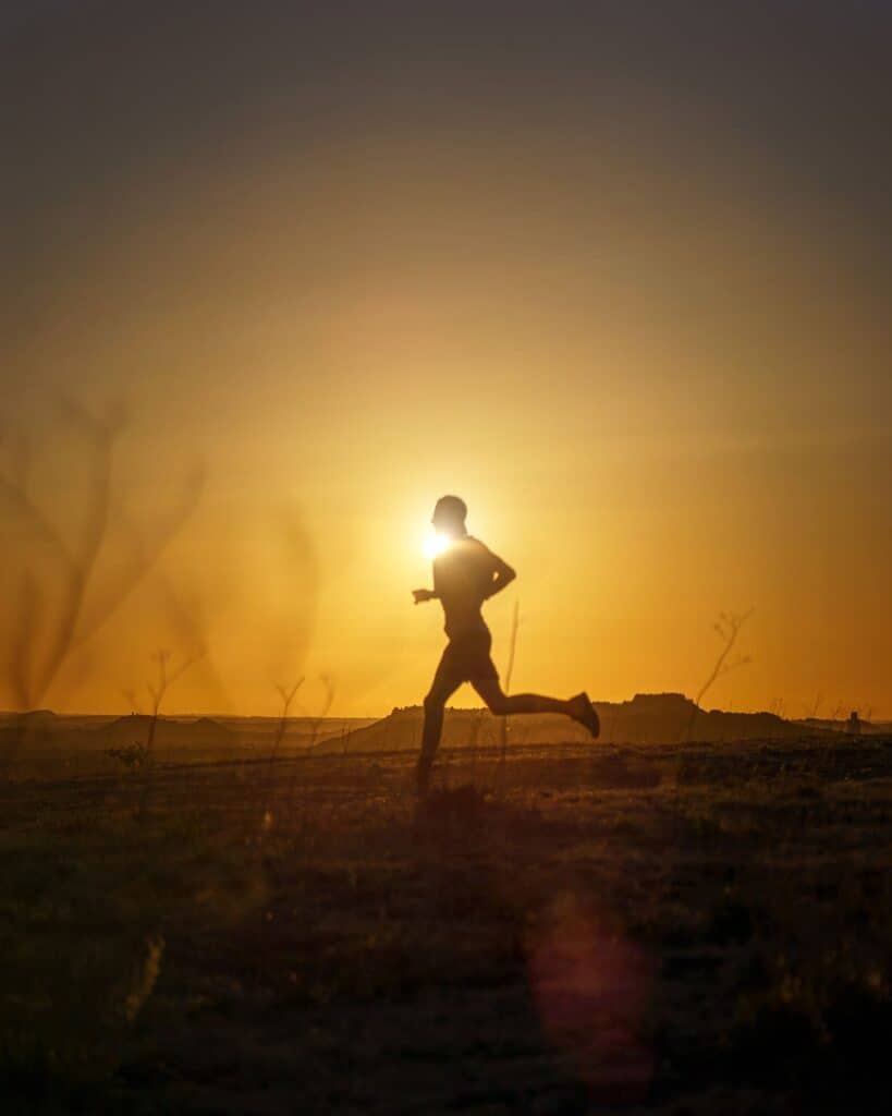 Person jogging outdoors at sunset, representing sun exposure and vitamin D