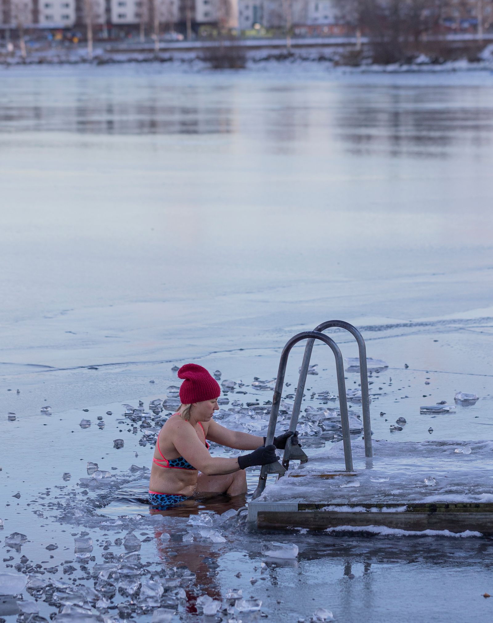 A woman taking a cold water dip during winter