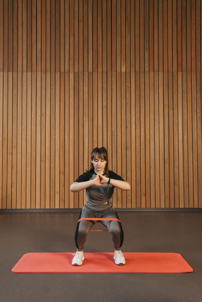 A woman exercising with a resistance band