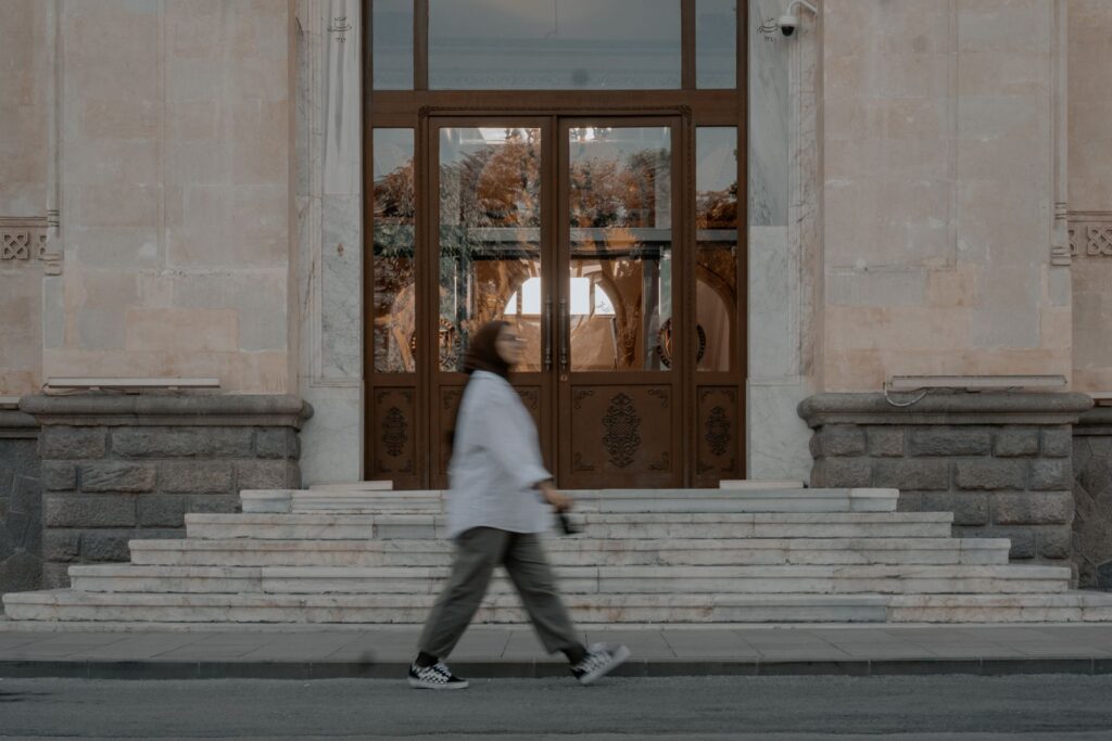 A woman walking briskly through a city street