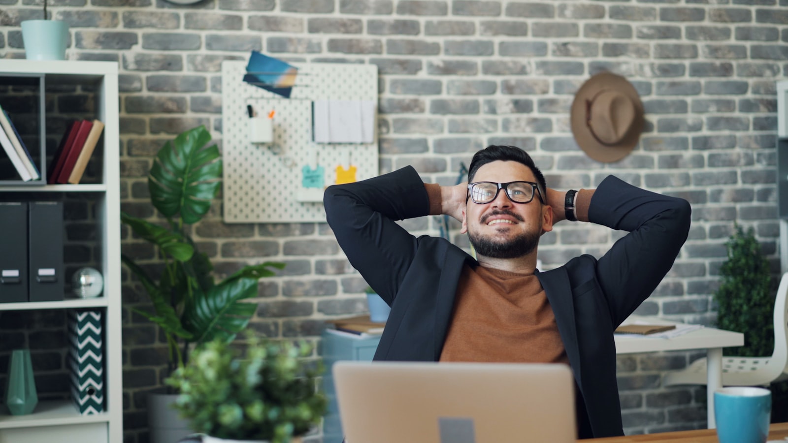 A man taking a stretching break at his desk
