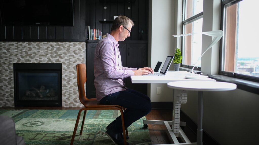 A man working at an office desk on a laptop