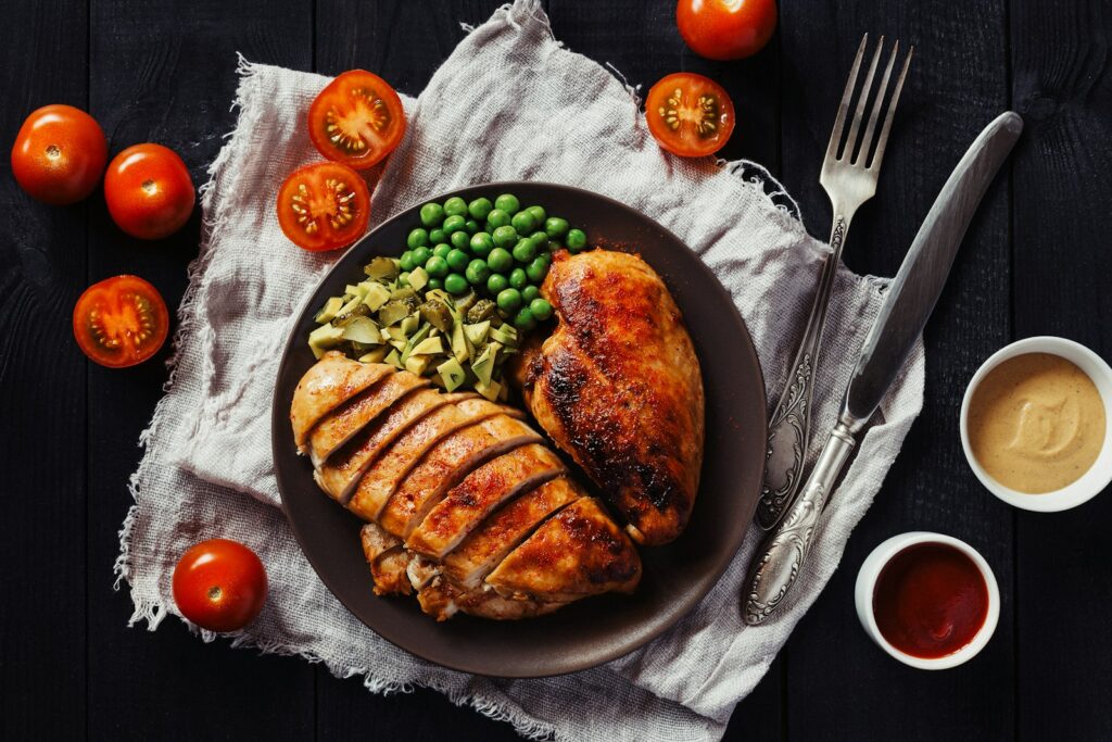 Sliced chicken breast on a plate with vegetables, a high-protein meal